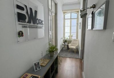 Bright hallway with a reception console and company logo on glass.