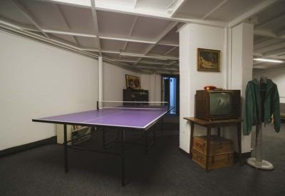 Recreational room with a purple ping-pong table and vintage television set.