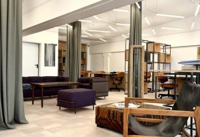 Lounge area with purple velvet seating, wooden coffee tables, and floor-to-ceiling curtains.