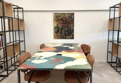 Close-up of a collaborative meeting table featuring a colorful abstract map design.