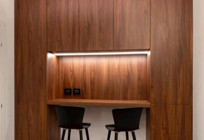 Wood-paneled breakout nook with a high counter and black bar stools.