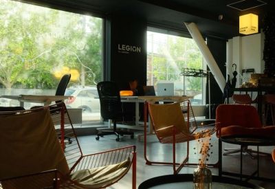Sunlit common area with assorted seating near large windows.