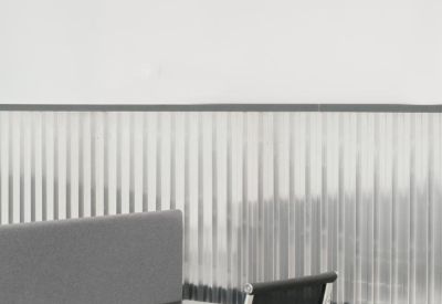 Close-up of a modern workstation with a privacy screen and ergonomic chair.