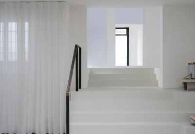 White interior stairs leading to an upper level with large skylights.