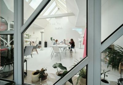 Spacious, bright common area at Komerční Banka Building, 1st Floor, Masarykova 1299, Ostrov with skylights and plants.