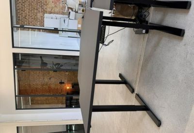 Adjustable height standing desk in a bright office space.