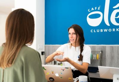 A staff member at the branded reception desk of 15 Calle del Poeta Joan Maragall, Bernabéu, Madrid.