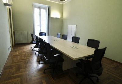Spacious boardroom at 16 Via Vanchiglia, Borgo Vanchiglia, Turin featuring parquet floors and natural light.