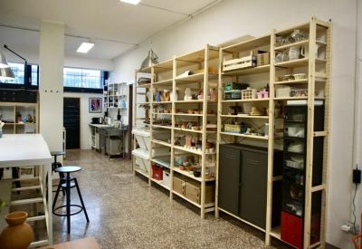Detailed view of floor-to-ceiling wooden shelving filled with supplies and equipment.