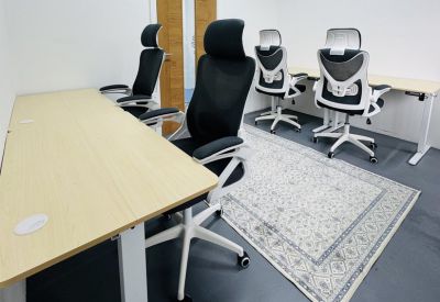 A modern workspace at 29-39 London Road, Twickenham with ergonomic black chairs and light wood desks.