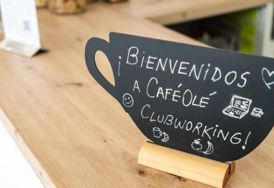 Close-up of a cup-shaped chalkboard sign welcoming visitors to the clubworking space.