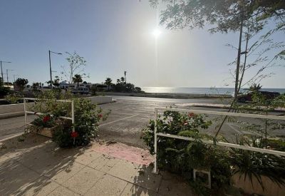 Outdoor view from the office entrance overlooking the Mediterranean coast and beach.