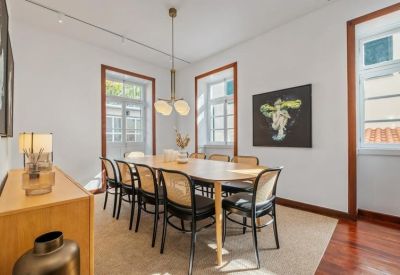Elegant dining or meeting room with a large wooden table and designer chairs.