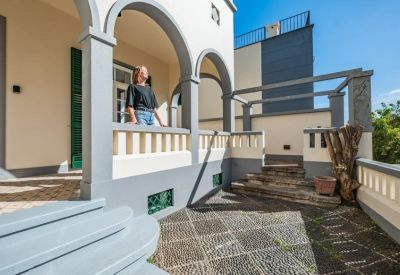 Traditional building exterior featuring arched entryways and stone stairs.