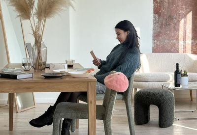 Communal dining area at 44, ulitsa Dunav, Floor 3 with a large wooden table and person working on a phone.