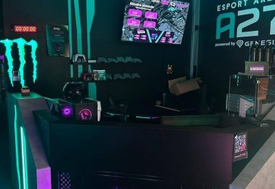Modern black reception desk with neon green and purple accents under LED strip lights.