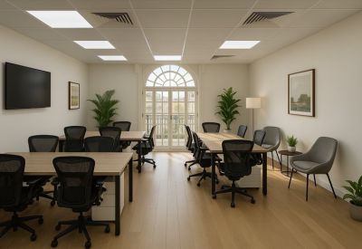 Bright, spacious open-plan office with wooden floors, indoor plants, and arched windows.