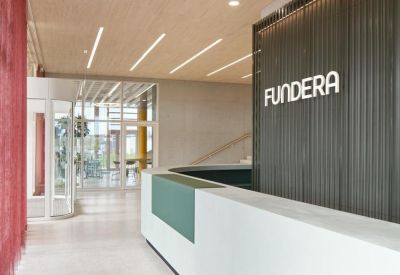 Bright reception area featuring a minimalist white desk and Fundera branding.