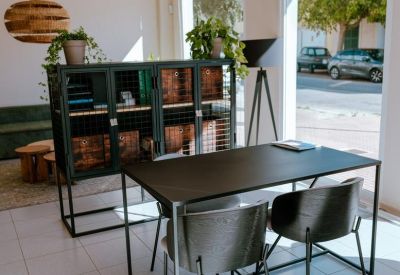 Reception area or consultation space with a black desk, modern chairs, and a window view.