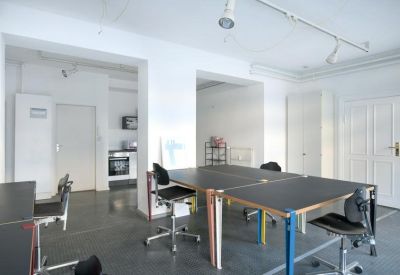 Bright office room featuring multiple workstations and minimalist decor.