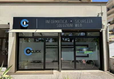 Exterior storefront of the 6C, Via L. Morelli office building with black signage and glass doors.