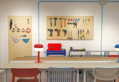 Workshop area featuring a tool pegboard and colorful desk lamps.