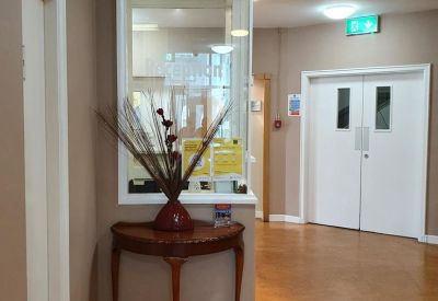 Lobby area with a decorative table and elevator doors.