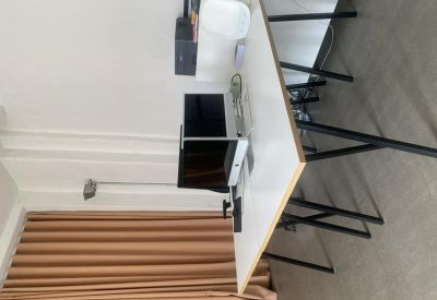 Close-up of an office desk with a computer and keyboard in a bright room.