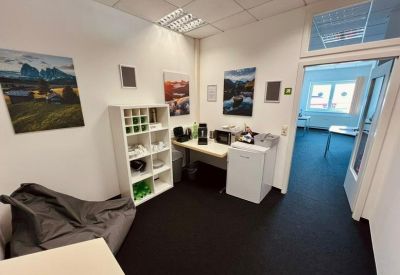 Breakout area with a bean bag chair, coffee station, and white storage shelving.