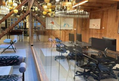 Spacious office interior featuring a wooden staircase and glass partitions.
