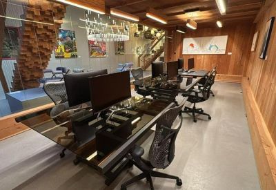 Sleek workspace with long black desks and ergonomic seating.