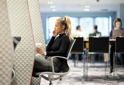 Individual workstation booth with padded sound-dampening walls for private phone calls or focus.