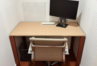 Quiet focus room with sound-absorbing walls and a dual-monitor setup.