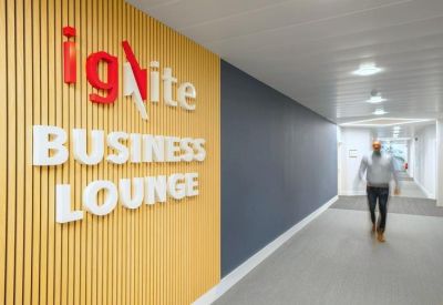 Modern office hallway featuring wood-slat walls and bold signage.