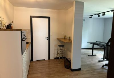 Break area featuring a small wooden breakfast bar with a tall stool next to the kitchen.