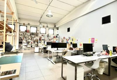 Spacious, sunlit open-plan office at Via Strecciola 5, Malgrate with high ceilings and skylights.