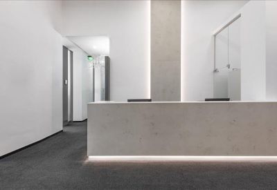 Minimalistic reception area with a modern desk.