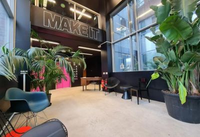 Vibrant reception area featuring large indoor plants and modern furniture.