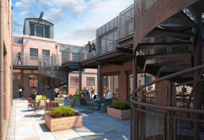 Exterior view of the brick courtyard and spiral staircase at Huguenot Place, 17 Heneage Street, London.