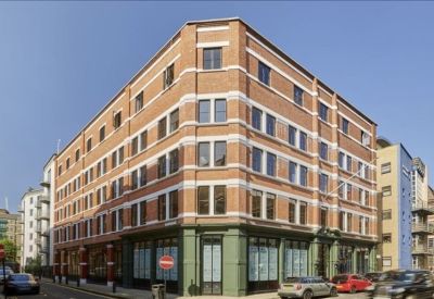 Contemporary reception desk with concrete finish and illuminated Goat Yard signage.