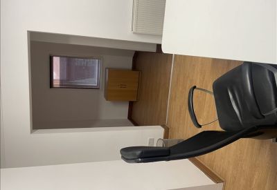 Interconnected office space featuring a wooden storage cabinet and views through an interior doorway.