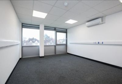 Private office space featuring large windows and an air conditioning unit.