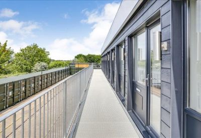 Upper-level balcony walkway providing access to several individual office suites.