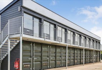 Ground floor storage containers located beneath the upper-level office units.