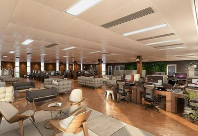 Open-plan coworking space with comfortable lounge seating and workstations.