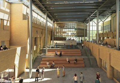 Spacious communal atrium with tiered wooden seating and high glass ceilings.