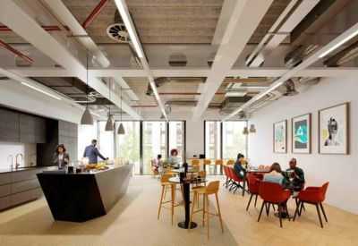 Bright communal kitchen and dining area with red chairs and a black island breakfast bar.