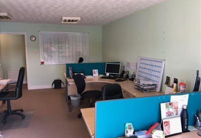 Bright workspace with multiple cubicles and a large wall-mounted calendar.