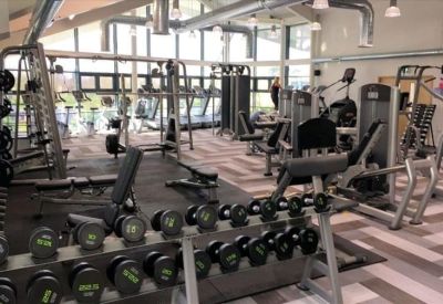 Spacious on-site gym featuring a variety of weight machines and cardio equipment.