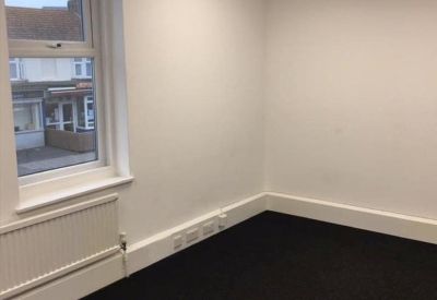 Bright private office suite with large window and white radiator.